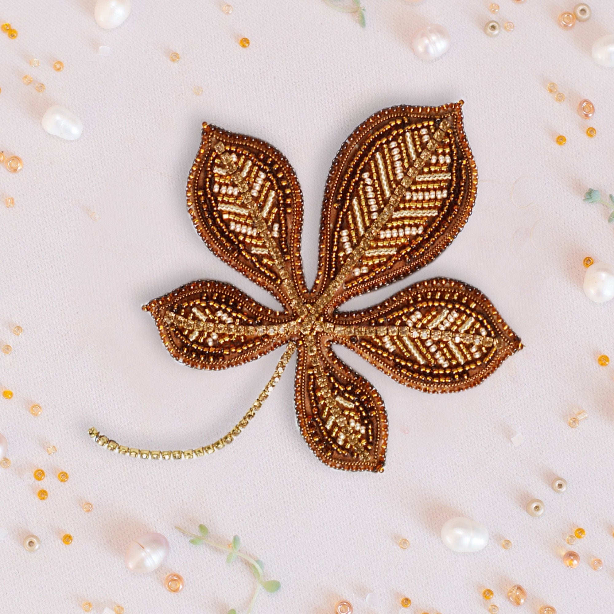 a brown flower with leaves on a white background